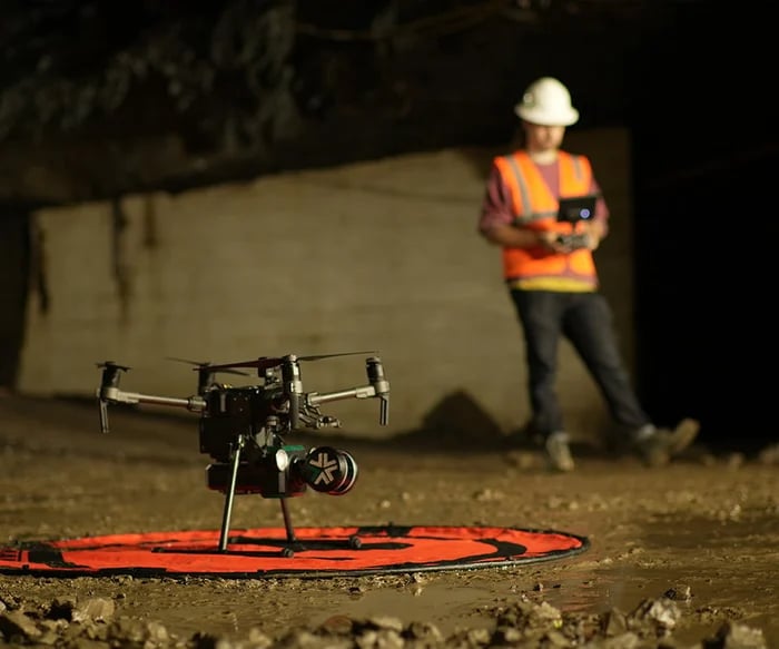 A man using drone 3d mapping software to conduct underground mapping